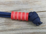 Medium Red G10 Lanyard Bead With Four Grooves and a Free Paracord Lanyard